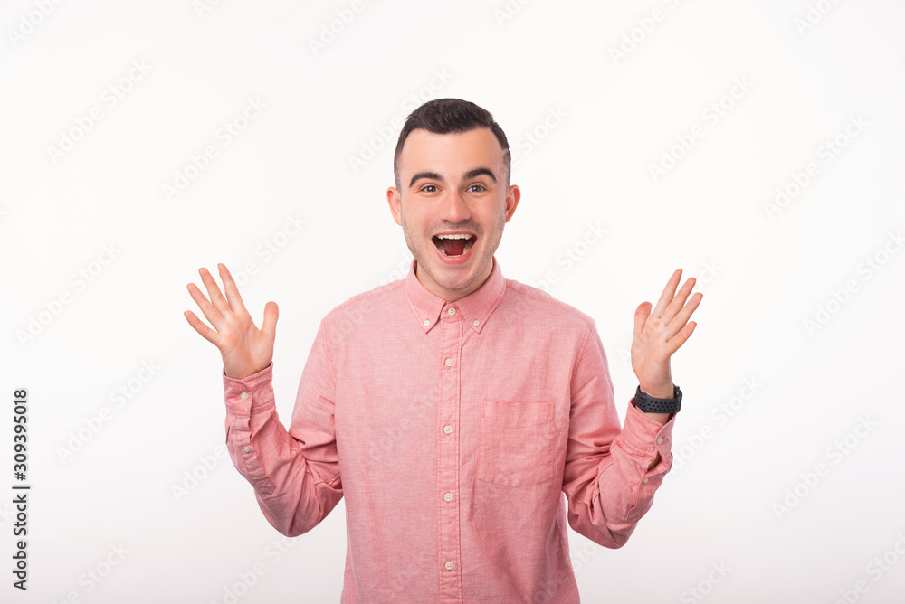 Photo of surprised young man gesturing over white background Photo of surprised young man gesturing over white background