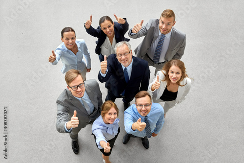 corporate, people and teamwork concept - happy smiling business team showing thumbs up © Syda Productions