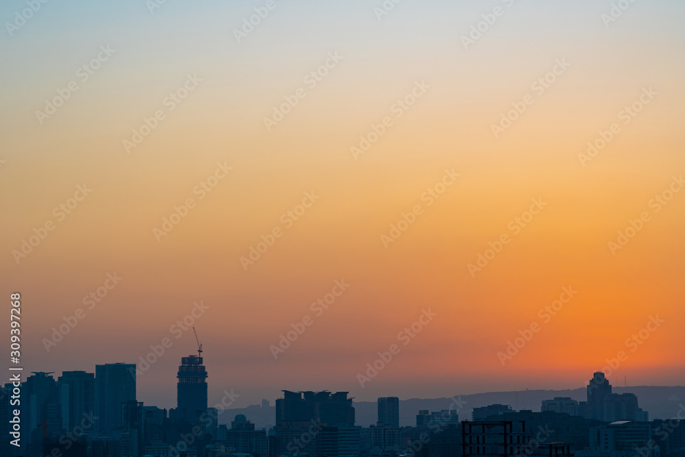 Fototapeta premium Modern city skyline in sunset time with colourful sky background