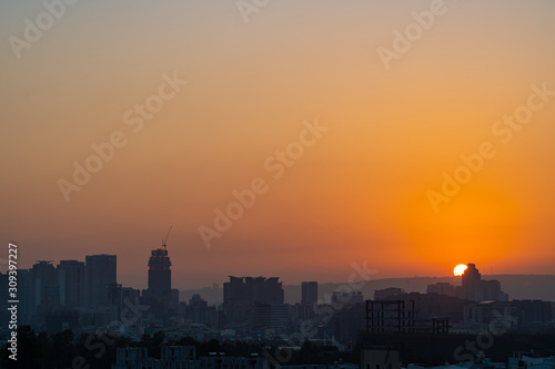 Modern city skyline in sunset time with colourful sky background