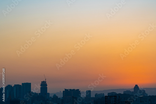 Modern city skyline in sunset time with colourful sky background