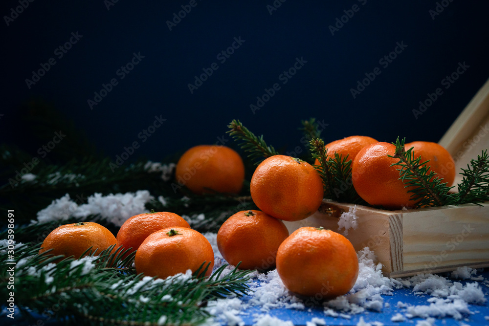 Tangerines in a wooden box handmade in the snow. Tangerines in a wooden box handmade in the snow.