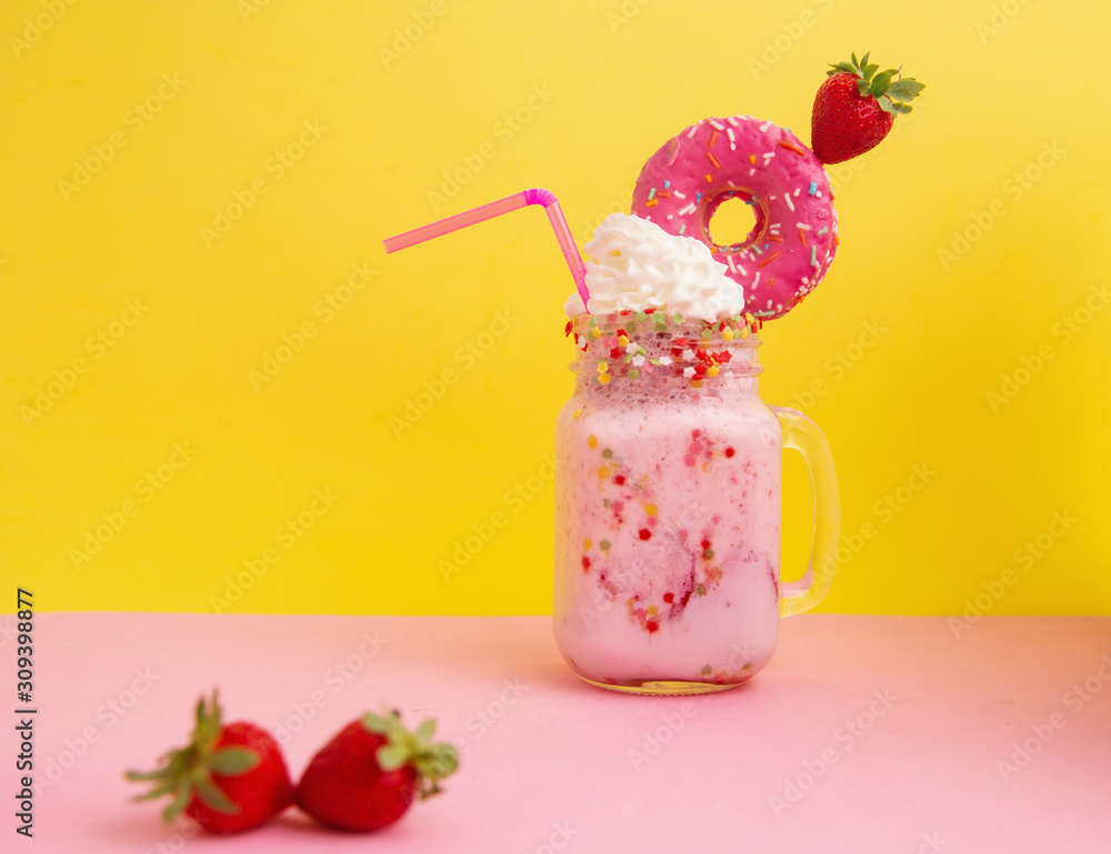 Delicious dessert strawberry smoothie with pink bagel and cream