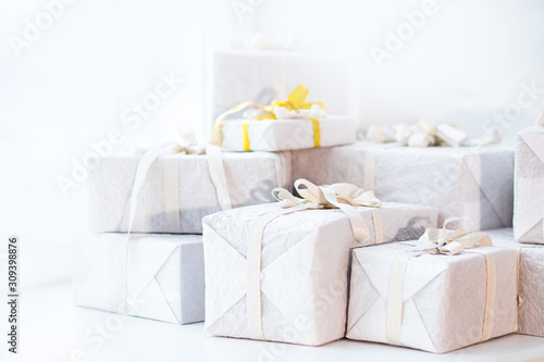 White christmas presents gift with silver ribbon bow, sunlight