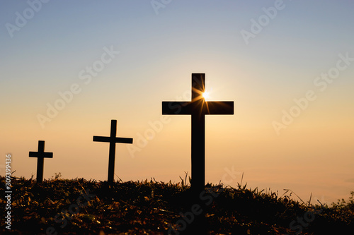 Leinwand Poster Silhouette cross on mountain at sunset background