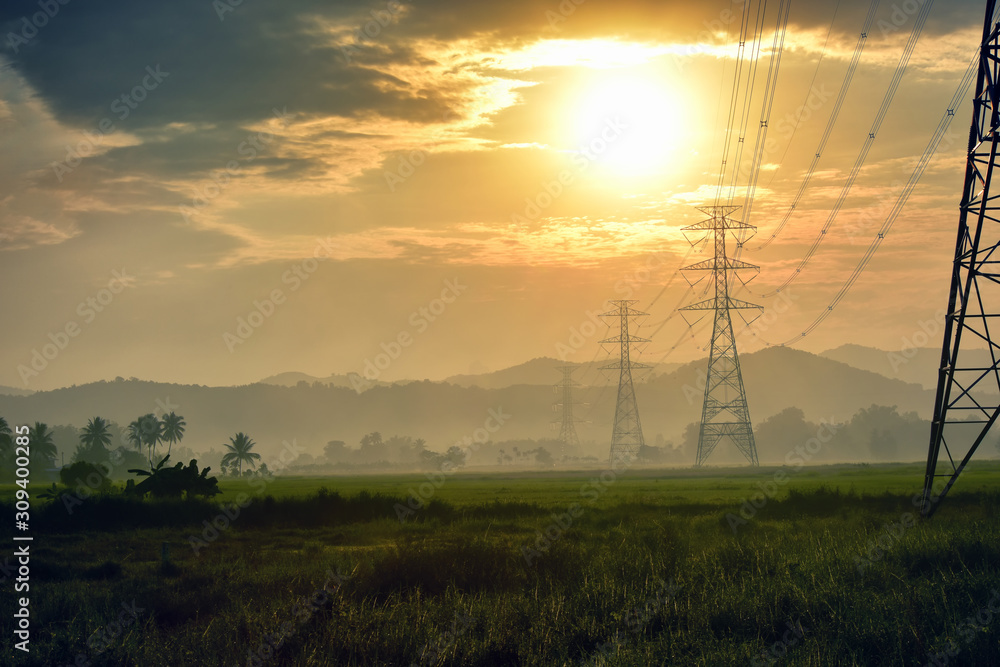 Obraz premium High voltage tower, Electric post and electric cable on the field in the countryside with in the morning sunrise background.