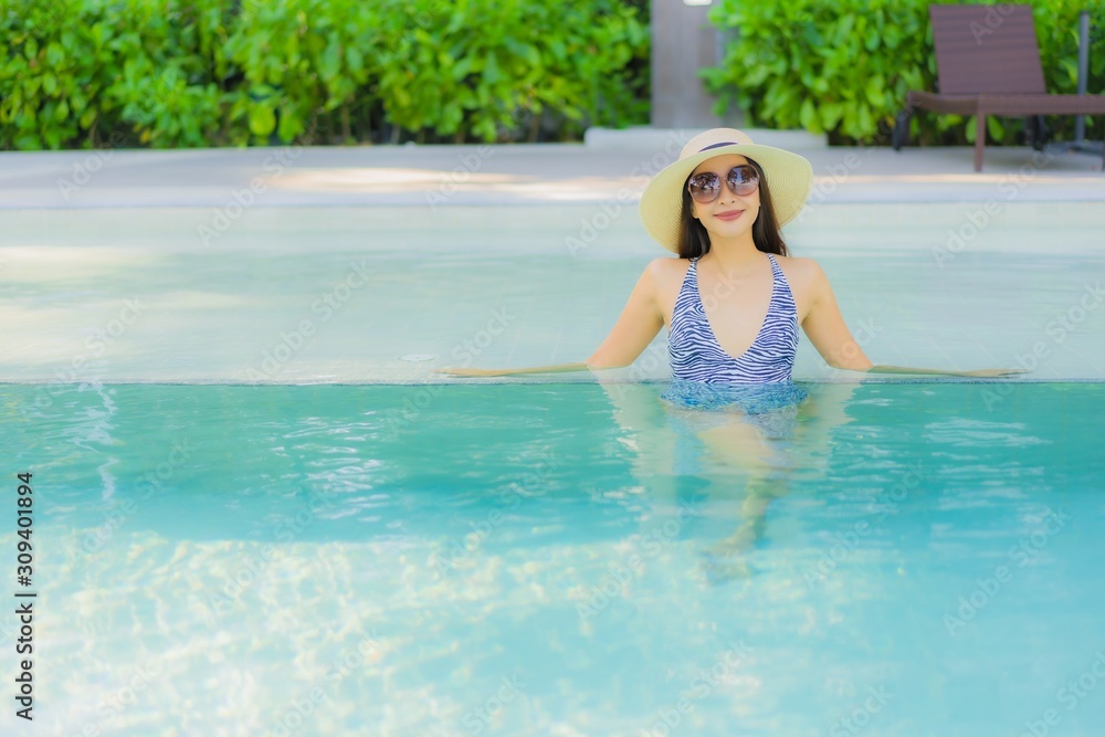 Beautiful young asian women happy smile relax around outdoor swimming pool in hotel resort for travel in holiday vacation