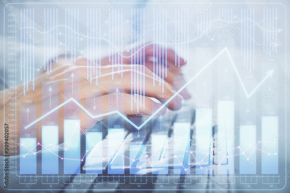Multi exposure of graph with man typing on computer in office on background. Concept of hard work. Closeup. Multi exposure of graph with man typing on computer in office on background. Concept of hard work. Closeup.