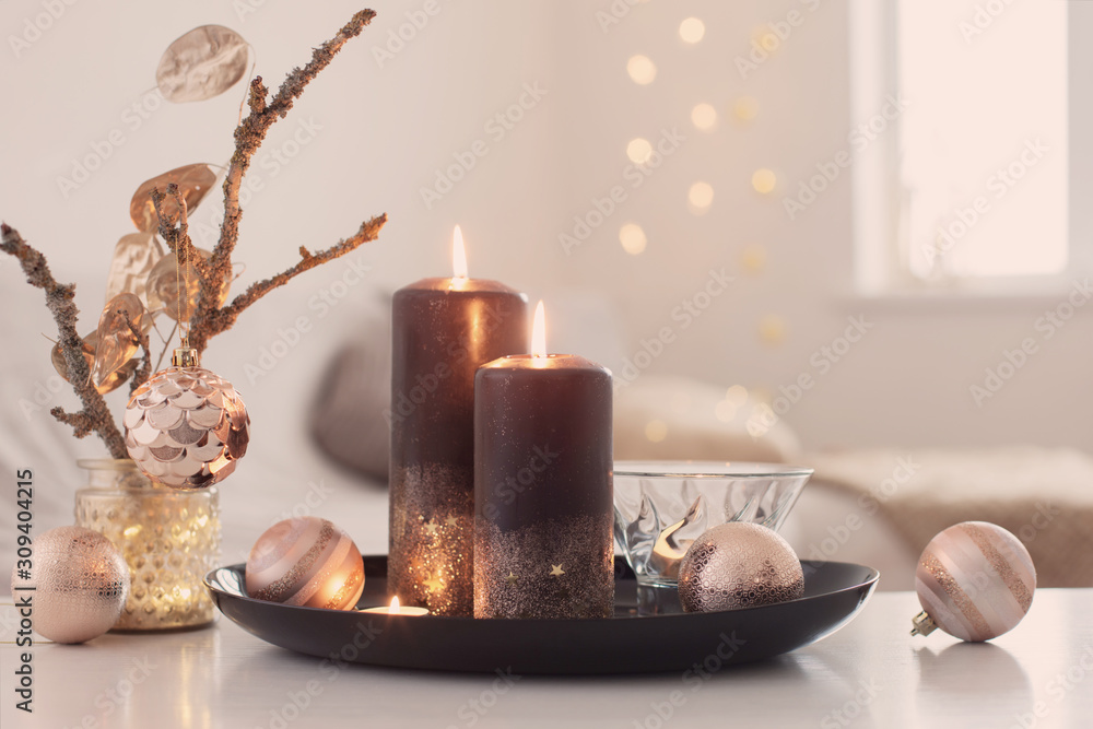 black burning candles with Christmas balls in white interior black burning candles with Christmas balls in white interior