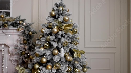 Merry Christmas. Christmas tree decorated with lights, Christmas interior background. Christmas tree with white and black balls.