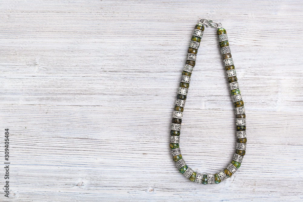 top view of antique jadeite necklace on gray top view of antique jadeite necklace on gray