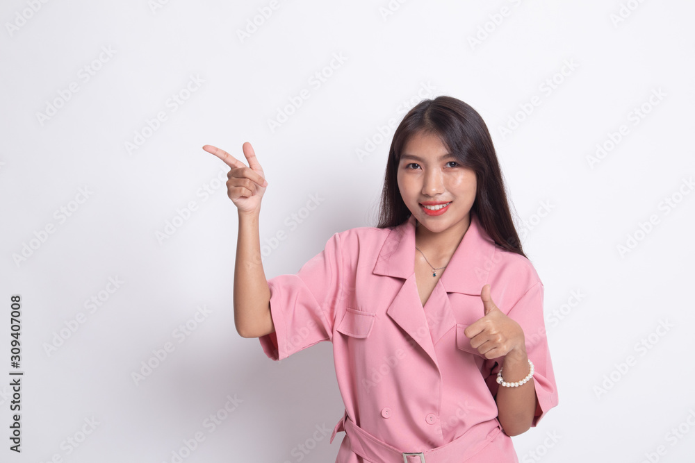 Young Asian woman point and thumbs up. Young Asian woman point and thumbs up.