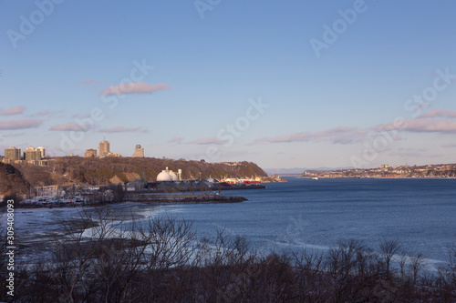 Aerial view from the Sillery hill of the St. Lawrence River, a small marina, buildings, round silos and boats, Quebec City, Quebec, Canada photo