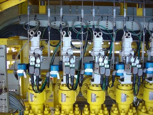 Tablou pe pânză Hydraulic choke or throttle valves ninety degree angle valve type at oil and gas wellhead remote platform with pressure transmitter to monitor downstream pressure