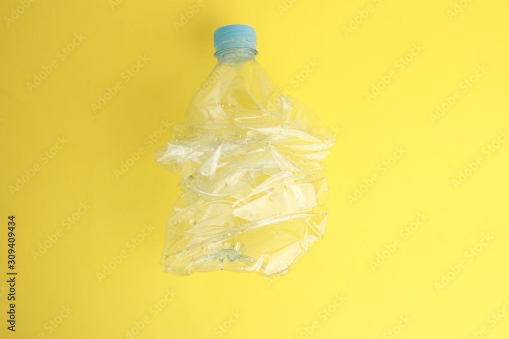 Empty plastic water bottle scaled for recycling