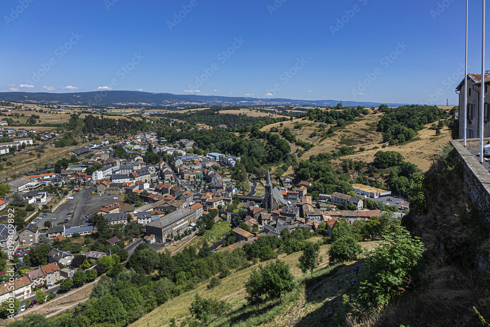 Picturesque view of Saint-Flour (Sant Flor) lower town. Ander and Margeride mountains in the background. Saint-Flour, Cantal department, Auvergne region, France.
