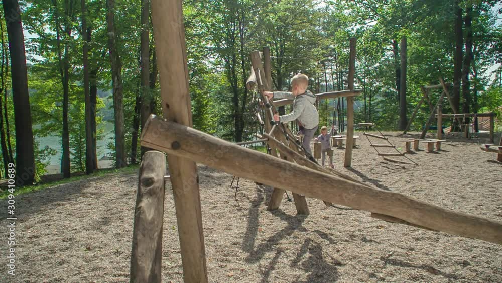 Boy climbs up spider web climber, girl gets stucked and mum runs to help her Boy climbs up spider web climber, girl gets stucked and mum runs to help her