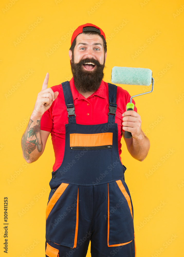 creative idea. inspired engineer designer ready to paint wall. repair concept. bearded man worker with roller tool. hipster builder in cap yellow background. erector assistant in work uniform creative idea. inspired engineer designer ready to paint wall. repair concept. bearded man worker with roller tool. hipster builder in cap yellow background. erector assistant in work uniform