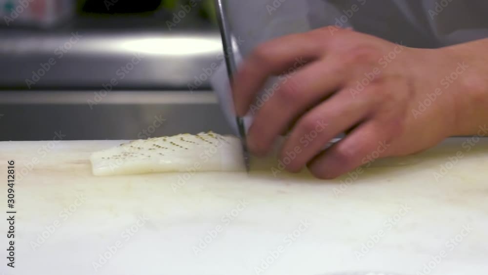 cook cuts fish at a restaurant and prepares a tasty meal cook cuts fish at a restaurant and prepares a tasty meal