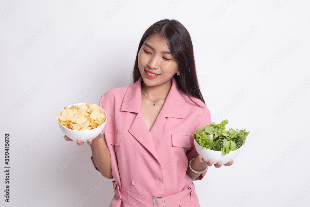 Young Asian woman with potato chips and salad. Young Asian woman with potato chips and salad.