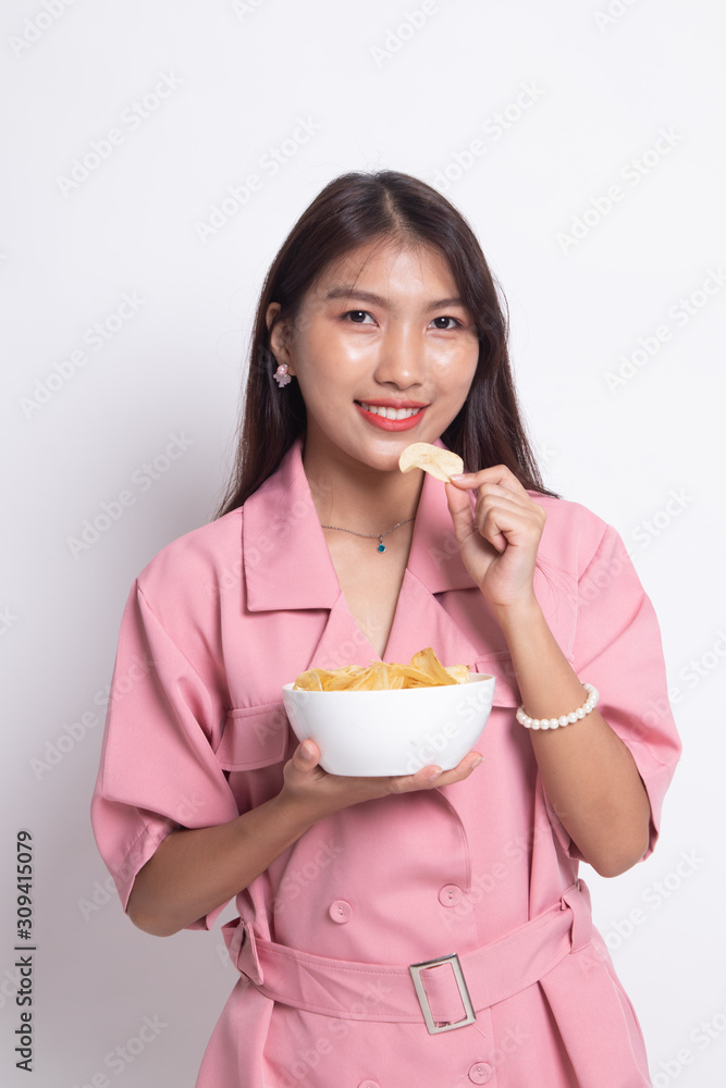 Young Asian woman eat potato chips.