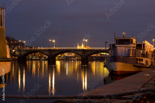  Night city landscape and panorama in the bright evening lights of the Czech capital Prague overlooking the Vltava River. © Olena