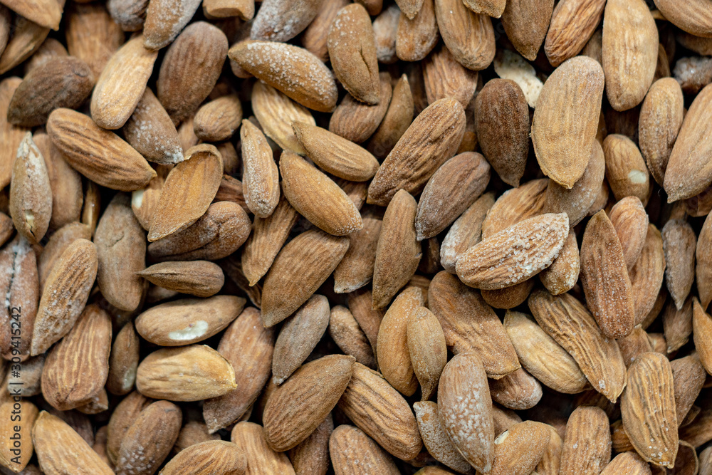 Peeled dry brown almond seed with mold plaque in bulk. Top View. Peeled dry brown almond seed with mold plaque in bulk. Top View.