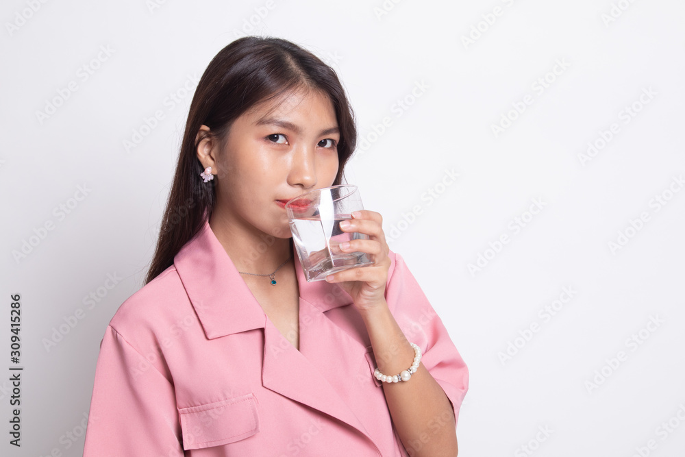 Young Asian woman with a glass of drinking water. Young Asian woman with a glass of drinking water.