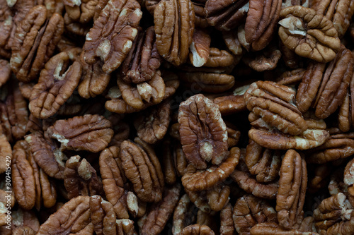 Peeled dry brown walnuts seeds in bulk. Top View.