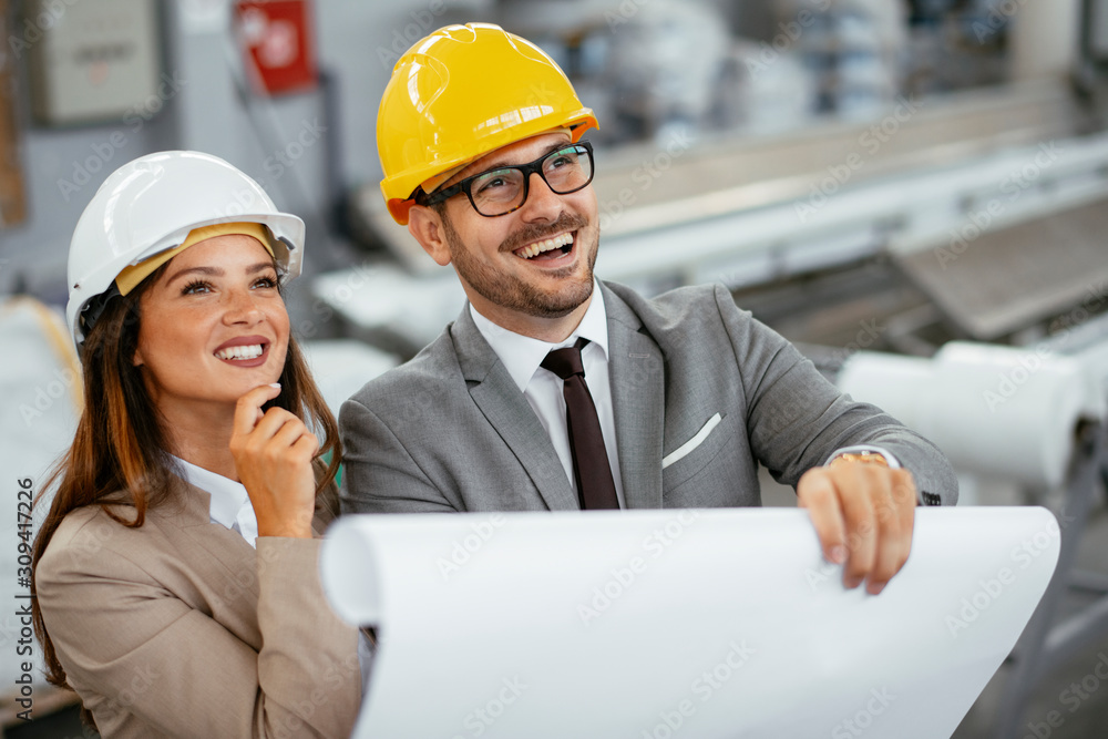Close up of colleagues in factory. Architects working on project.