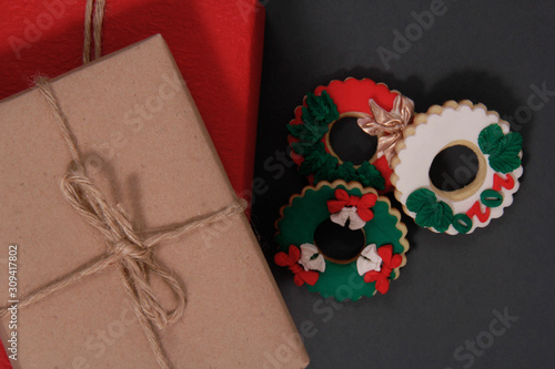 A paper wrapped gift and delicious Christmas cookies photo