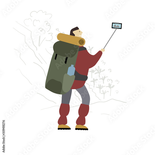 Hiker with backpack takes selfie in mountains.