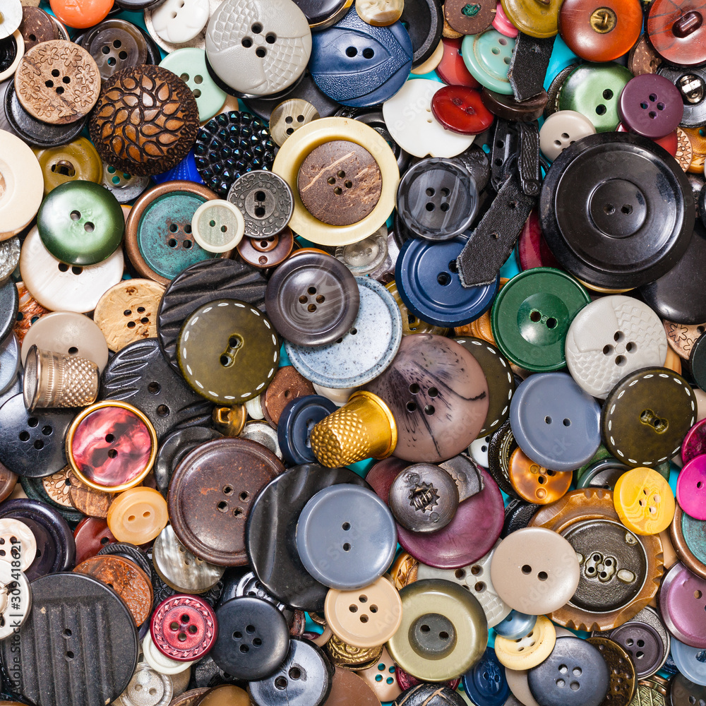 heap of many various buttons close up on blue heap of many various buttons close up on blue