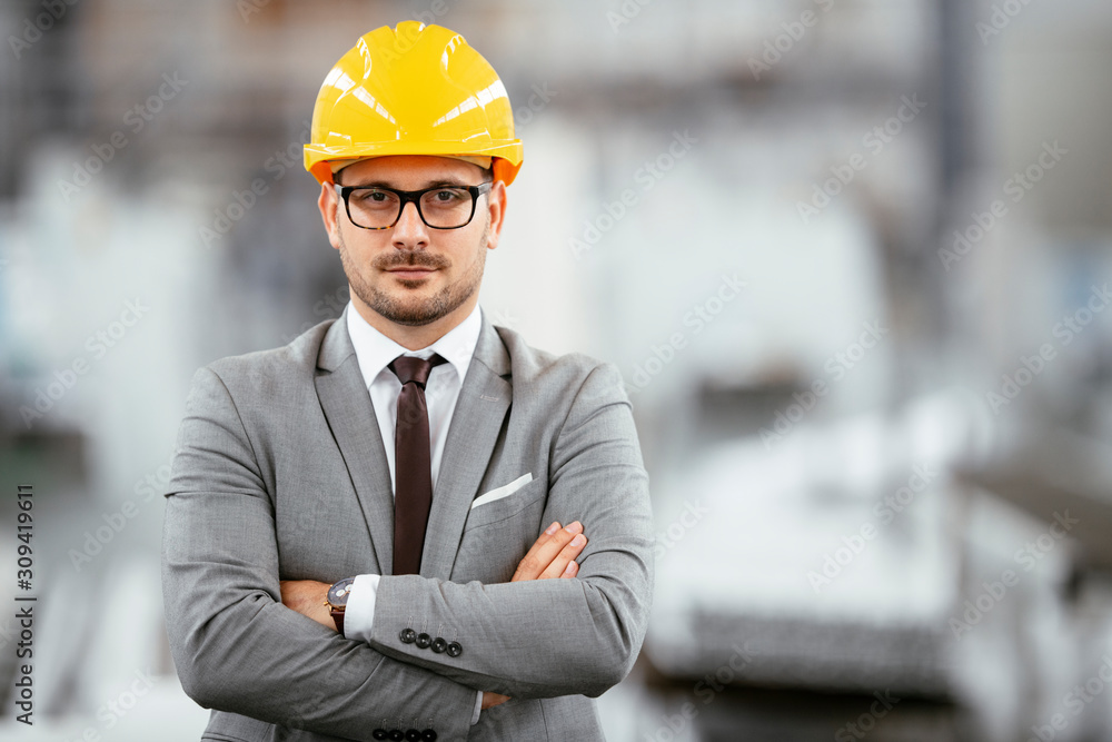 Portrait of successful businessman in factory. Handsome architect in suit. Portrait of successful businessman in factory. Handsome architect in suit.