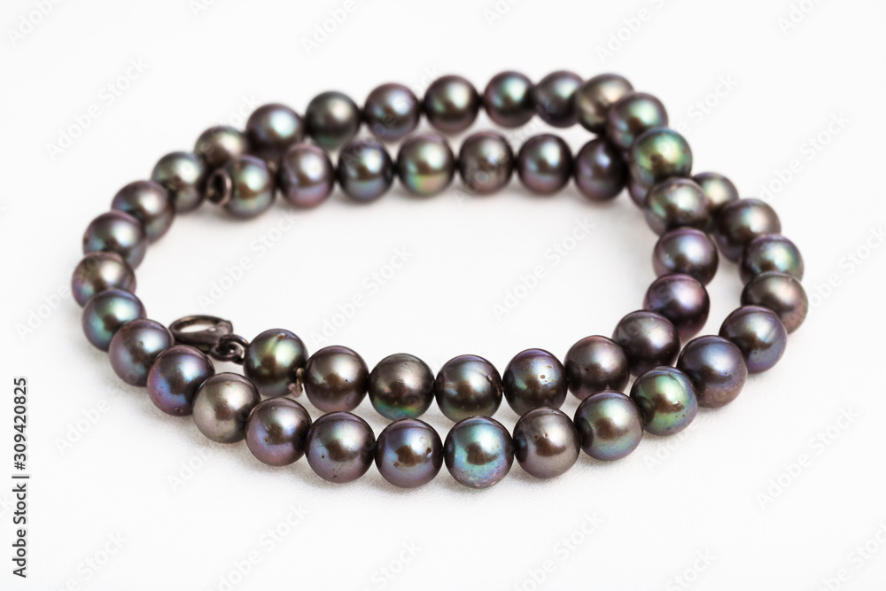 coiled necklace from natural black pearls on white coiled necklace from natural black pearls on white