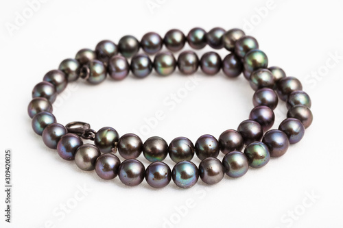 coiled necklace from natural black pearls on white