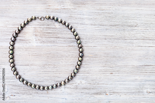 top view of natural black pearls necklace on gray