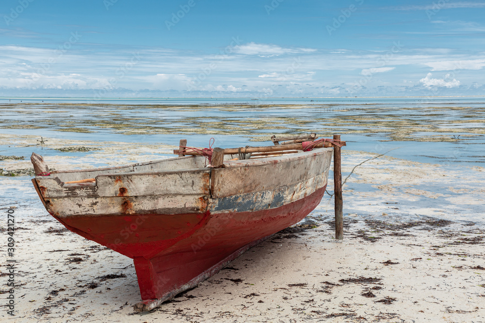 Boat on sand during low tide