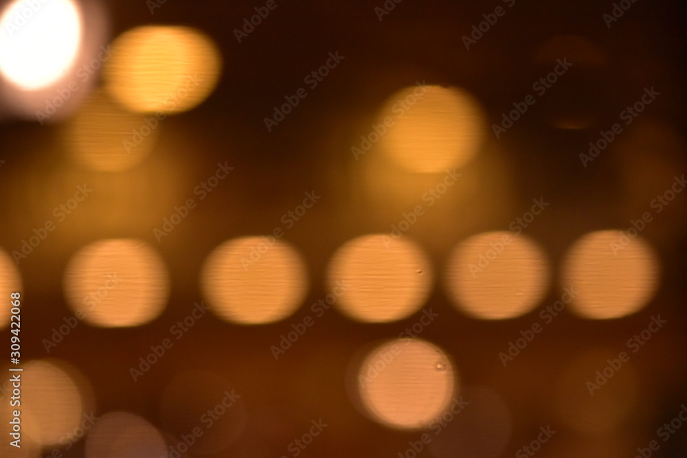 Obraz premium golden and colorful light bokeh at night on the road background 