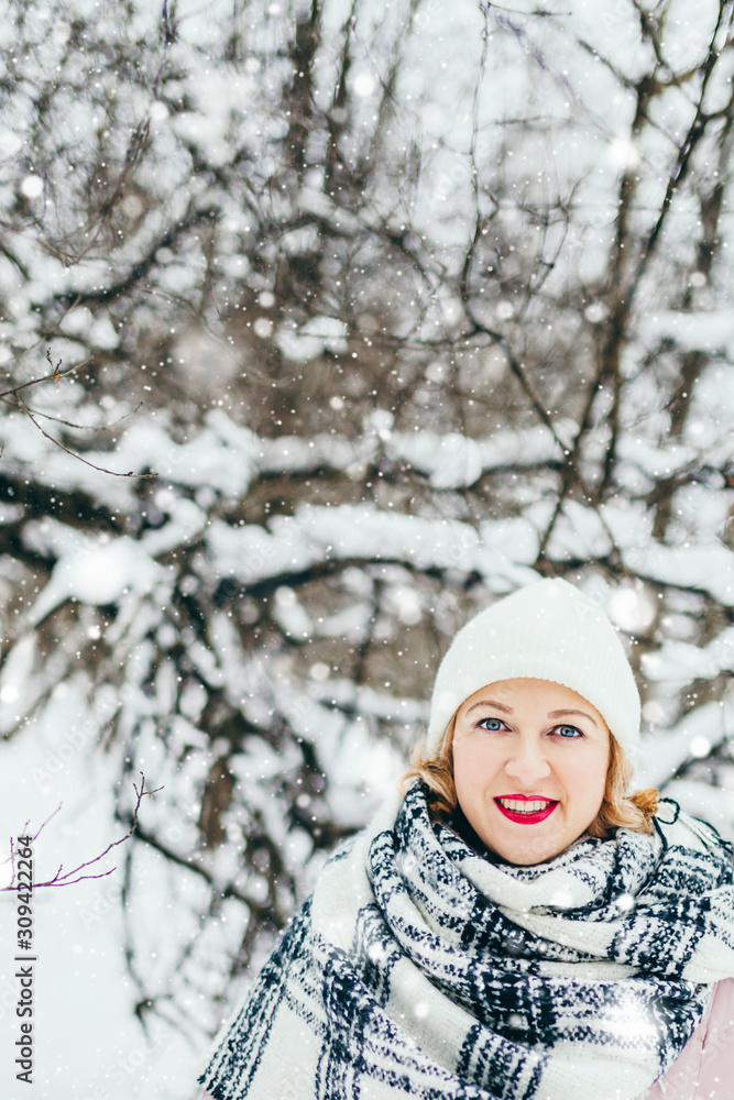 Closeup portrait of a young girl with a smile and bright big blue eyes in the winter forest Closeup portrait of a young girl with a smile and bright big blue eyes in the winter forest