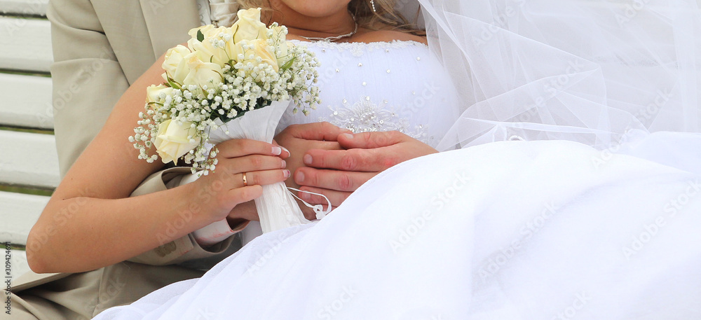 Beautiful wedding bouquet in hands of the bride Beautiful wedding bouquet in hands of the bride