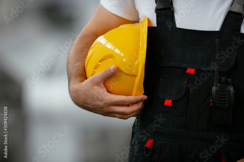 Close up of worker holding helmet