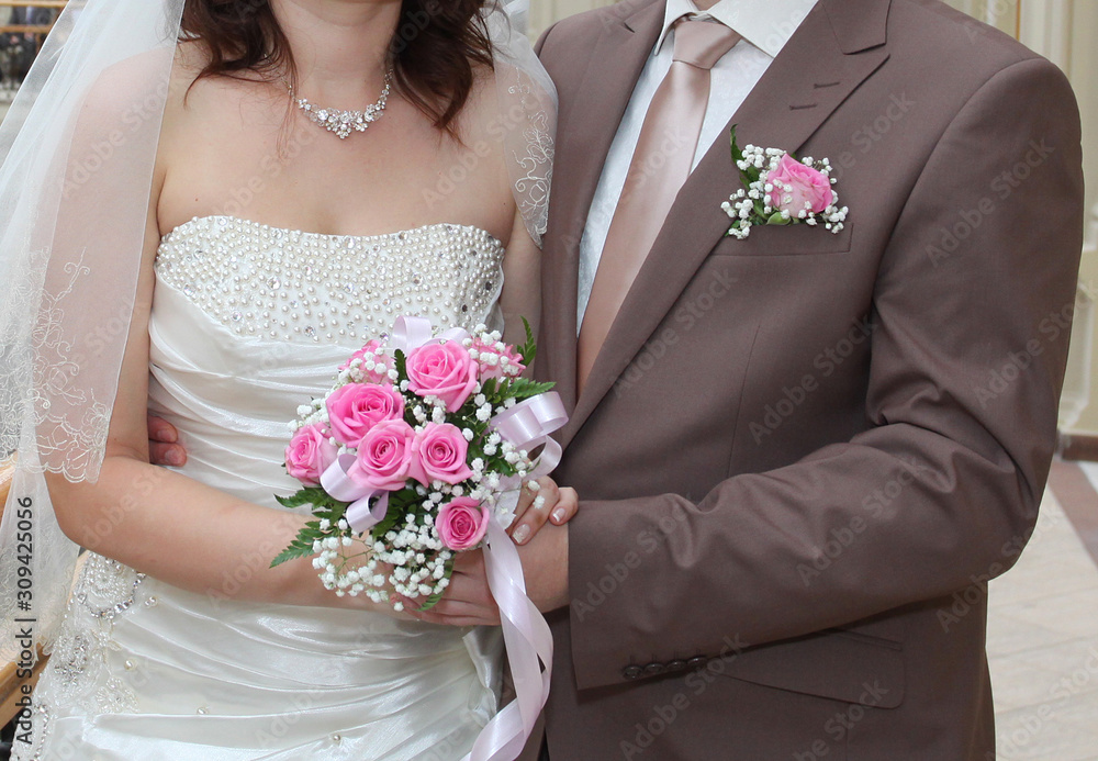 Beautiful wedding bouquet in hands of the bride