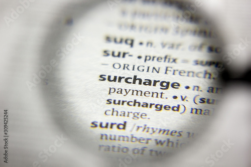 The word or phrase Surcharge in a dictionary. photo