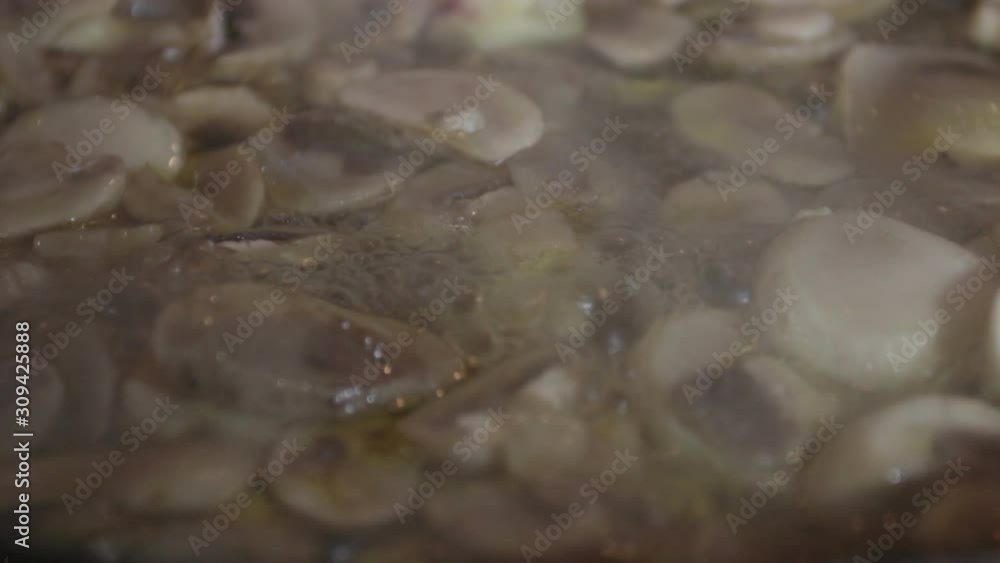 Close-up, Champignon mushrooms when cooked in a pan Close-up, Champignon mushrooms when cooked in a pan
