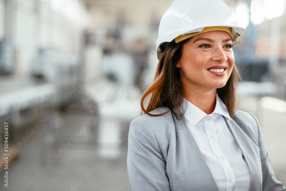 Young businesswoman with blueprint. Portrait of female architect in factory. Young businesswoman with blueprint. Portrait of female architect in factory.