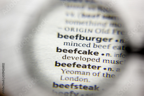 The word or phrase Beefcake in a dictionary. photo