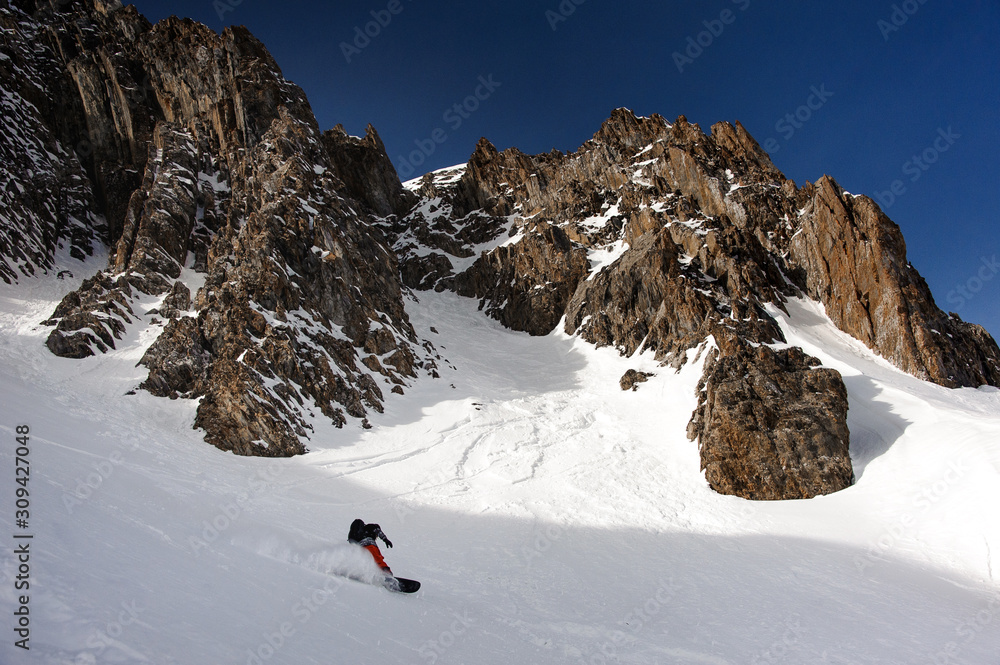 View at snowboarder sliding down the mountain side