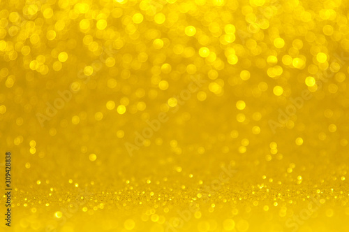 Abstract bokeh golden and yellow colors defocused circular background. Christmas light or season greeting background. .