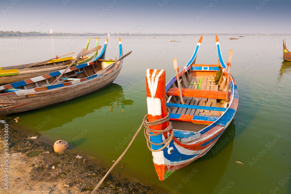 Myanmar.  Landscape. Boats in lake. Trash